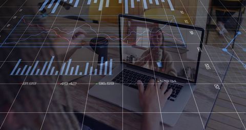 Woman Using Laptop for Remote Work with Digital Financial Graphs Overlay