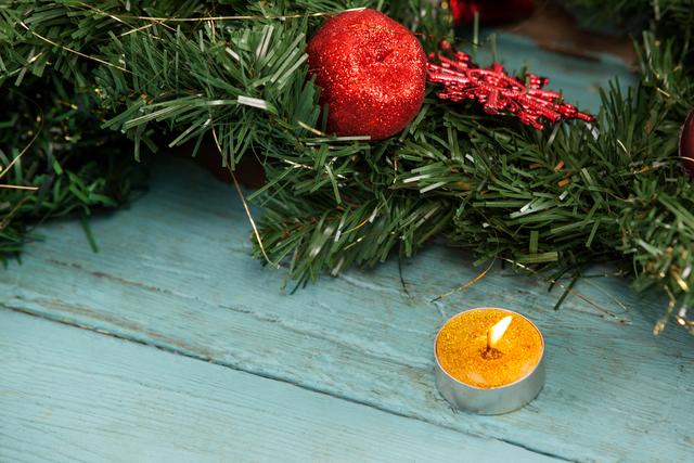Christmas decoration with tealight candle on a plank