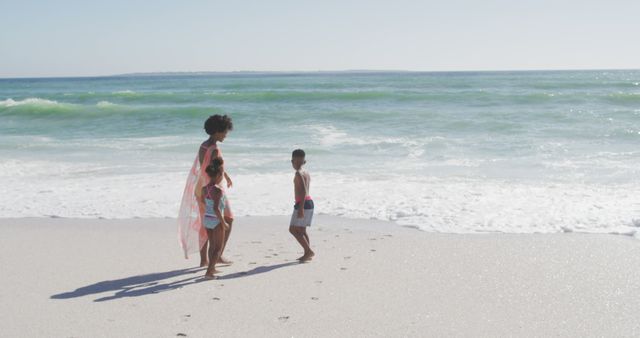 Family Enjoying Beach Vacation with Children on Sunny Day - Download Free Stock Images Pikwizard.com