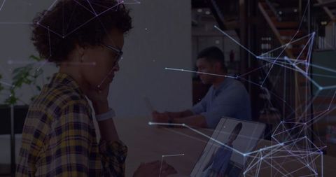 Businesswoman engaging with digital analytics on laptop