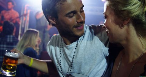 Young Couple Enjoying Night Out at Lively Party - Download Free Stock Images Pikwizard.com