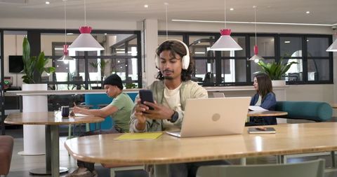 African american professionals working in modern coworking space with headphones