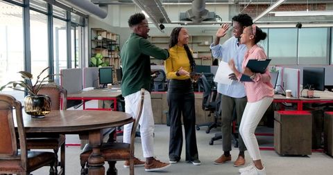 Diverse Team in Modern Office Collaborating Enthusiastically