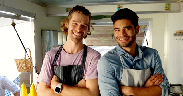 Two cheerful male small business owners standing in food truck kitchen - Download Free Stock Images Pikwizard.com