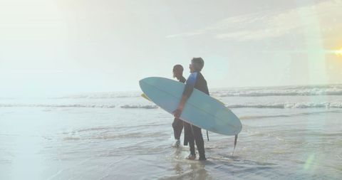 Senior Couple Enjoying Surfing at Sunny Beach - Download Free Stock Images Pikwizard.com