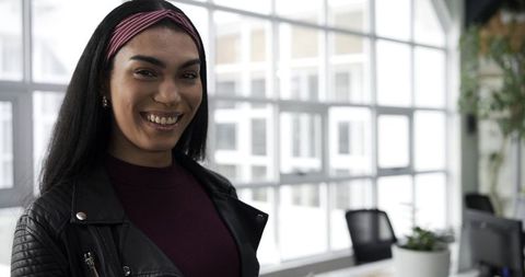 Young african american woman standing and smiling in contemporary office interior
