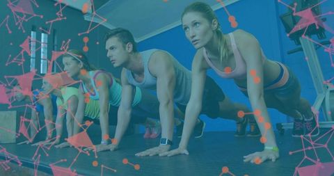 Group performing push-ups together in gym setting