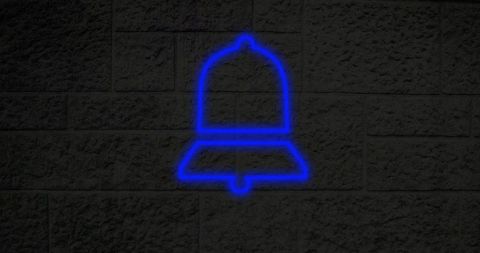 Neon Blue Bell Icon Glowing on Urban Brick Wall at Night