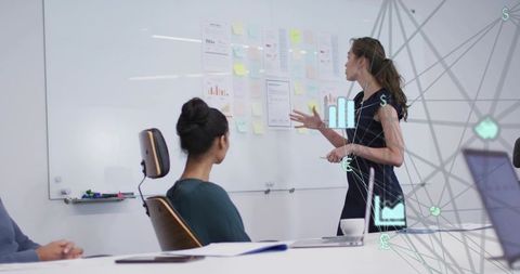 Business team collaborating on whiteboard strategy presenting sticky notes and data visuals