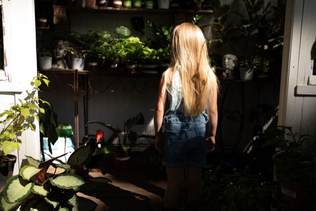 Girl Exploring Sunny Garden with Plants - Download Free Stock Images Pikwizard.com