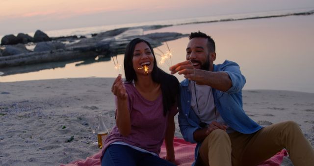 Couple Enjoying Sparklers at Sunset on Beach Picnic - Download Free Stock Images Pikwizard.com