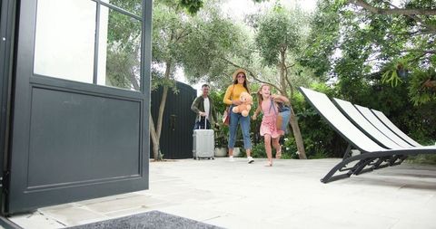 Family Returning from Vacation Celebrating in Backyard Moment