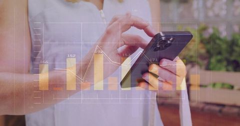 Tapping mobile phone with transparent bar and line charts on outdoor patio for analytics