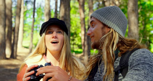 Happy couple exploring nature together wearing beanies in forest - Download Free Stock Images Pikwizard.com