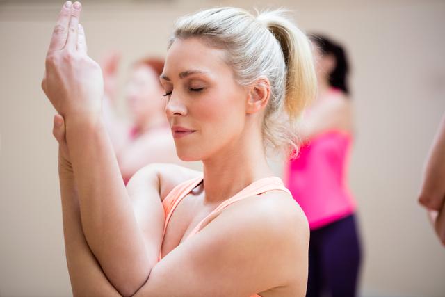 Woman performing hand exercise in the fitness studio