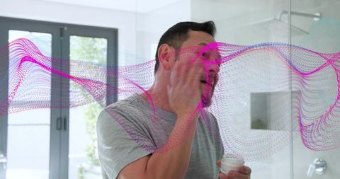 Man applying facial moisturizer in modern bathroom holding jar with pink digital wave