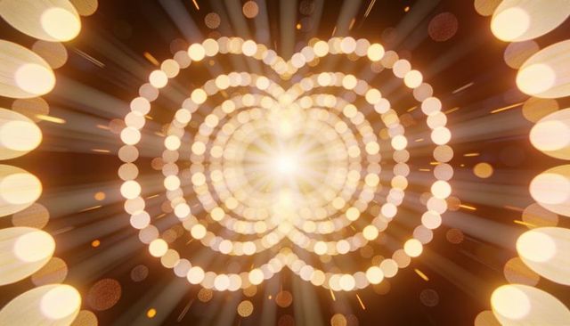 Golden radiant heart bokeh rings with central flare — warm glowing abstract background