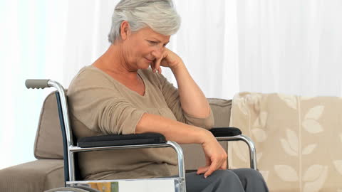 Senior Woman in Wheelchair Deep in Thought at Home