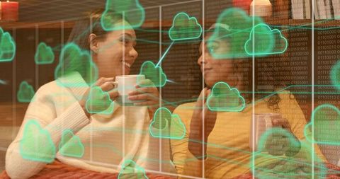 Women Holding Mugs and Talking on Sofa with Cloud Computing Overlay for Remote Lifestyle