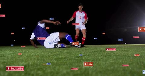Dynamic Soccer Tackle Amid Floating Digital Icons on Floodlit Field