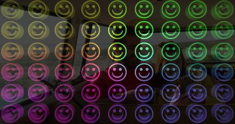 Colorful smiley icons overlaying couple on train journey