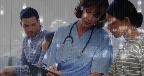 Nurse in scrubs documenting patient consultation