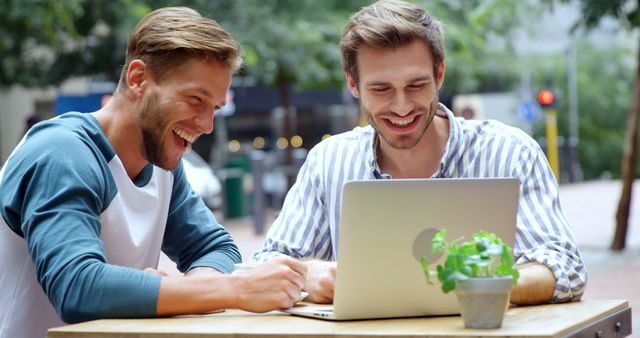 Two Young Men Working Together Outdoors on Laptop - Download Free Stock Images Pikwizard.com