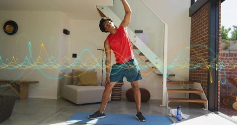 Man Doing Lateral Stretch on Blue Mat in Modern Living Room with Fitness Waveforms