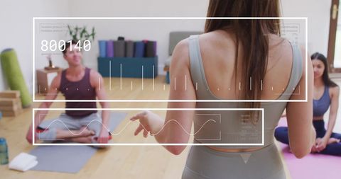 Yoga Class with Digital Data Overlay Featuring Female Instructor