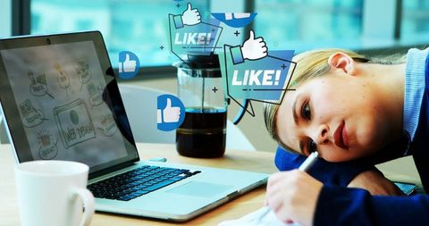 Businesswoman overwhelmed by digital notifications working on laptop