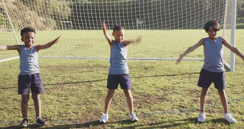 Children Exercising with Joy on Soccer Field Enjoying Teamwork