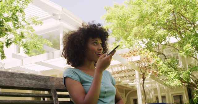 Young Woman Enjoying Relaxed Phone Conversation Outdoors - Download Free Stock Images Pikwizard.com