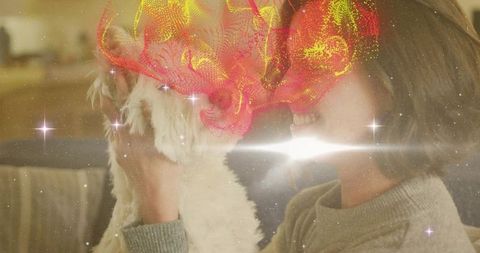 Woman cuddling small white dog on sofa with dreamy sparkles and colorful abstract overlay