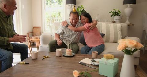 Diverse Seniors Celebrating Happy Birthday on Cozy Sofa