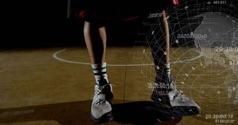 Standing Athlete Sneakers on Gym Court Featuring Digital Globe Overlay and Dramatic Shadow