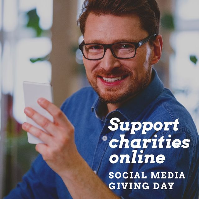 Support charities online text with smiling caucasian mid adult man holding smart phone. support charities online, social media giving day, wireless technology, lifestyles, social media giving day.