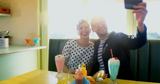 Couple Dining in Retro Cafe Taking Selfie with Milkshakes - Download Free Stock Images Pikwizard.com