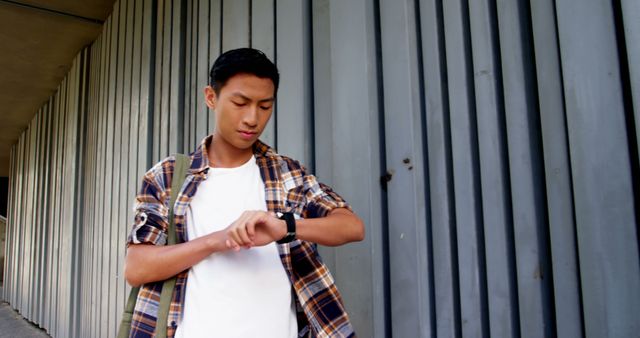 Young Man Checking Smartwatch on Street Walkway - Download Free Stock Images Pikwizard.com