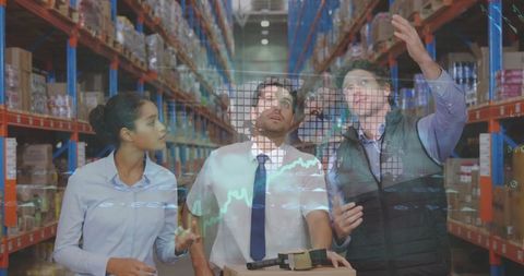Diverse warehouse team analyzing financial data in logistics center