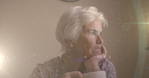 Reflective Senior Woman Contemplating Retirement while Sipping Tea