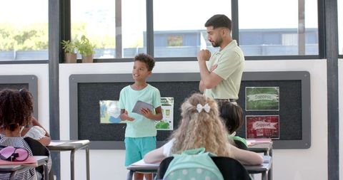Confident boy presenting in school classroom