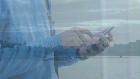 Hands Typing on Smartphone Overlaying Cityscape