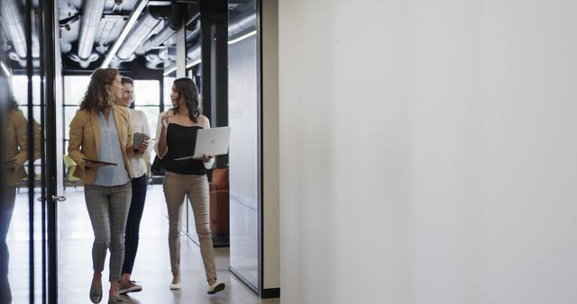 Businesswomen Walking Through Modern Office Hall with Laptops - Download Free Stock Images Pikwizard.com