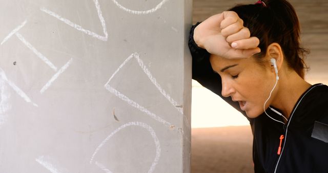 Exhausted Woman Resting After Intense Workout with Earbuds - Download Free Stock Images Pikwizard.com