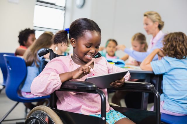 Disabled Schoolgirl Using Digital Tablet in Classroom - Download Free Stock Photos Pikwizard.com
