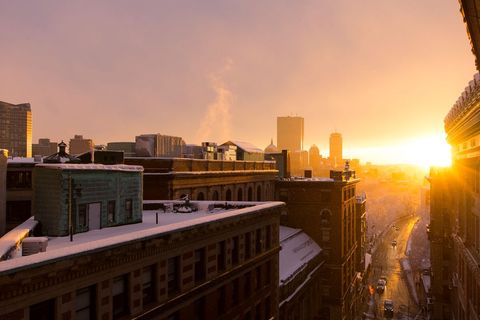 Snow-Covered Cityscape at Winter Sunset