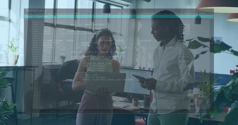 Collaborating colleagues holding tablet and documents in modern office with code overlay
