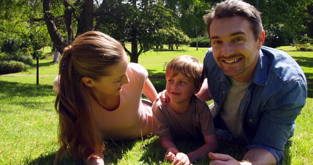 Happy Family Lying on Grass in Sunny Park - Download Free Stock Images Pikwizard.com