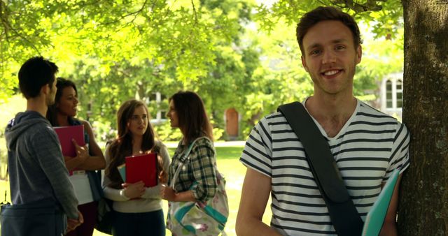 Smiling Student Carrying Notebook in Campus Courtyard - Download Free Stock Images Pikwizard.com