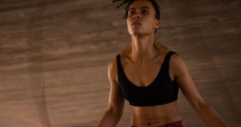 Focused Young Woman Skipping Rope for Fitness in Urban Area